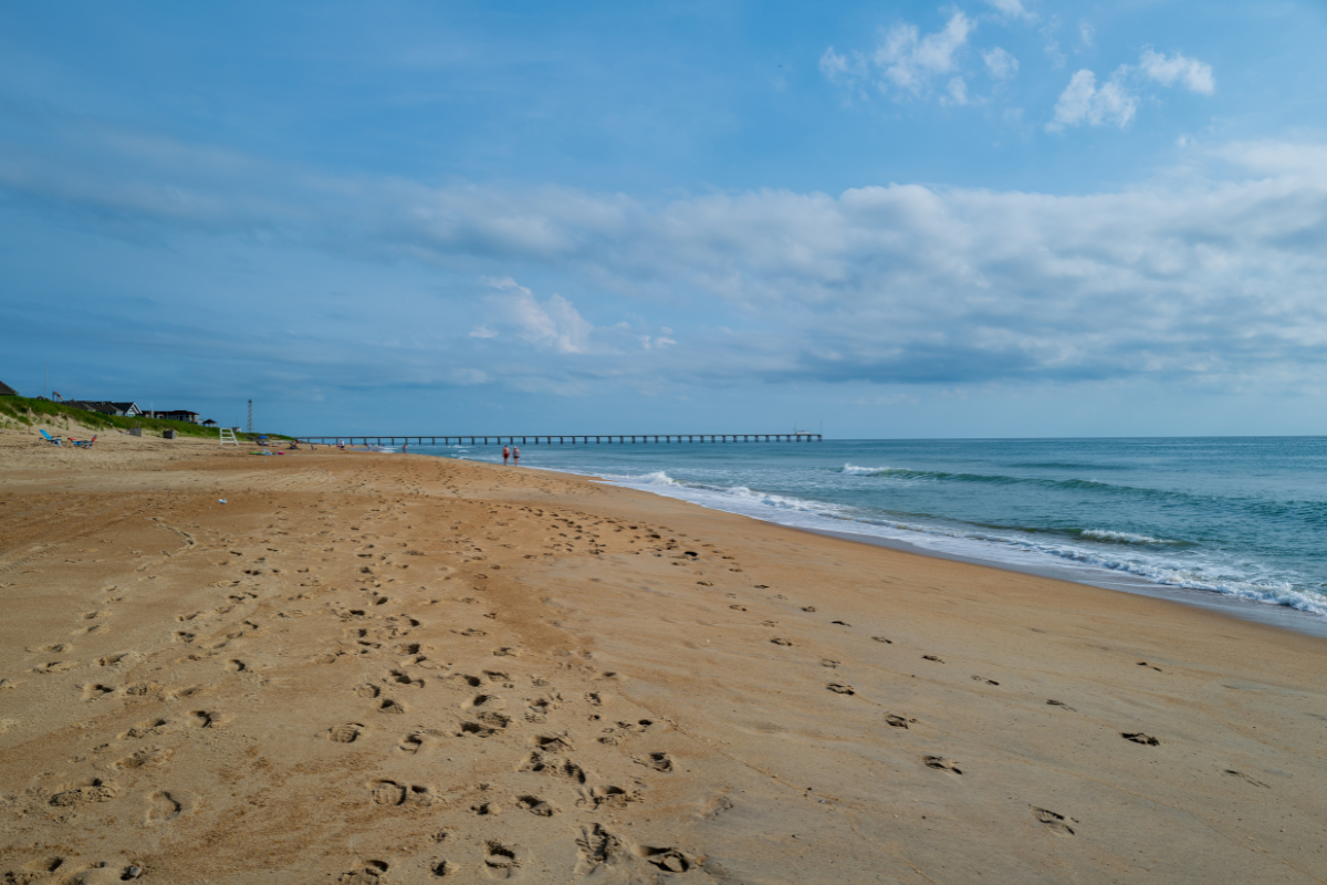 A clean beach with waves rolling in located in Duck NC